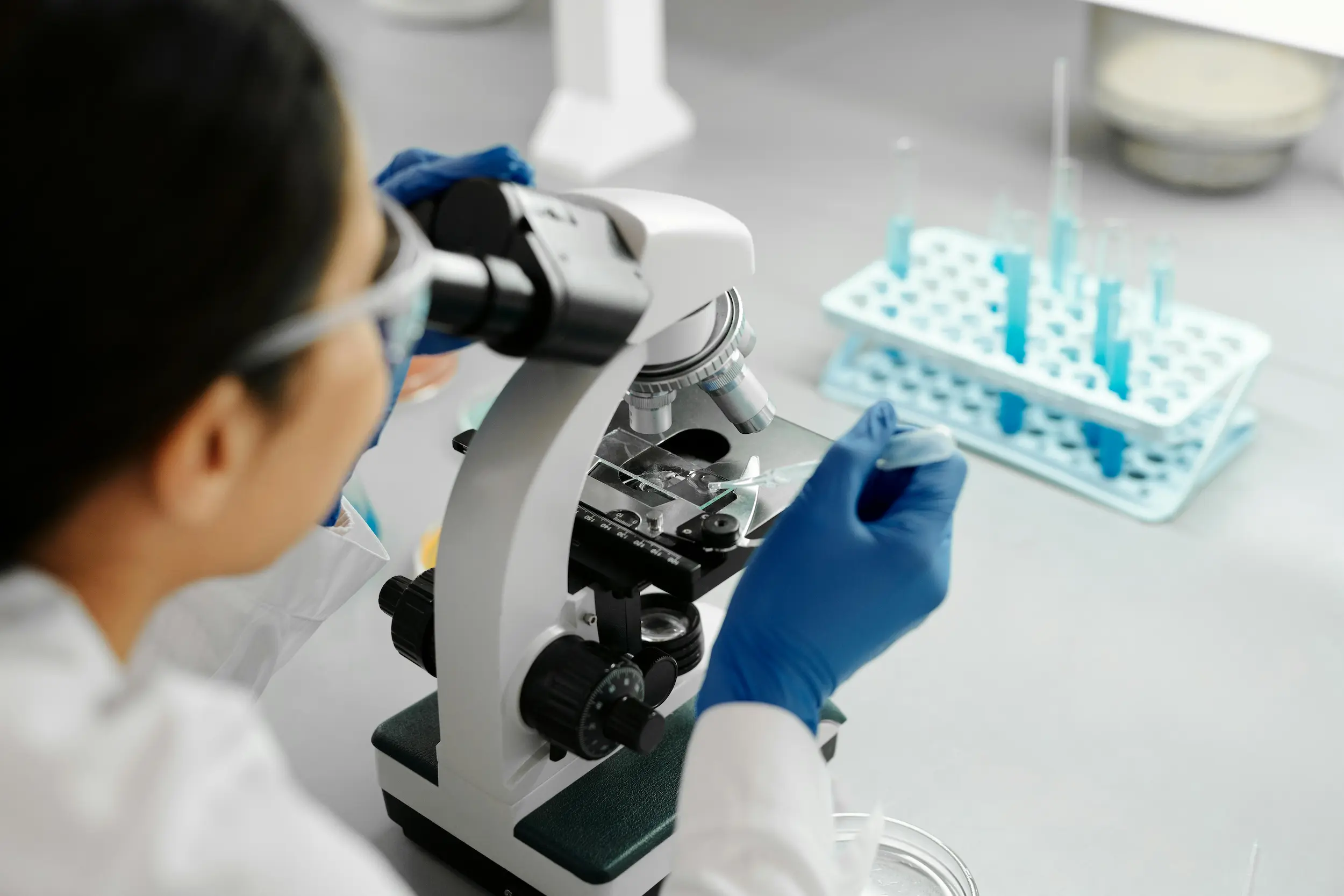 Researcher using a microscope in a laboratory